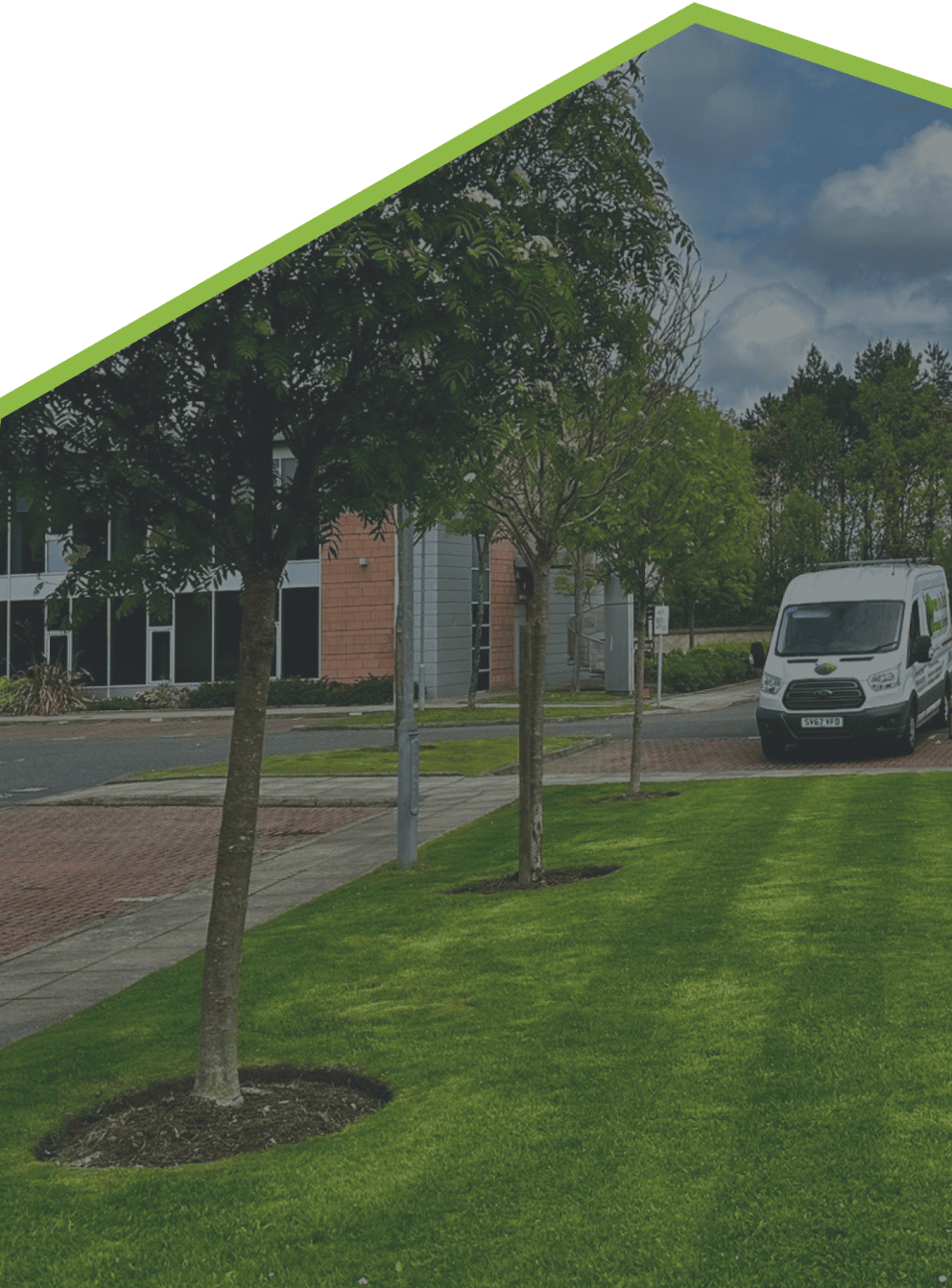background image of an industrial estate with a van and tools beside it